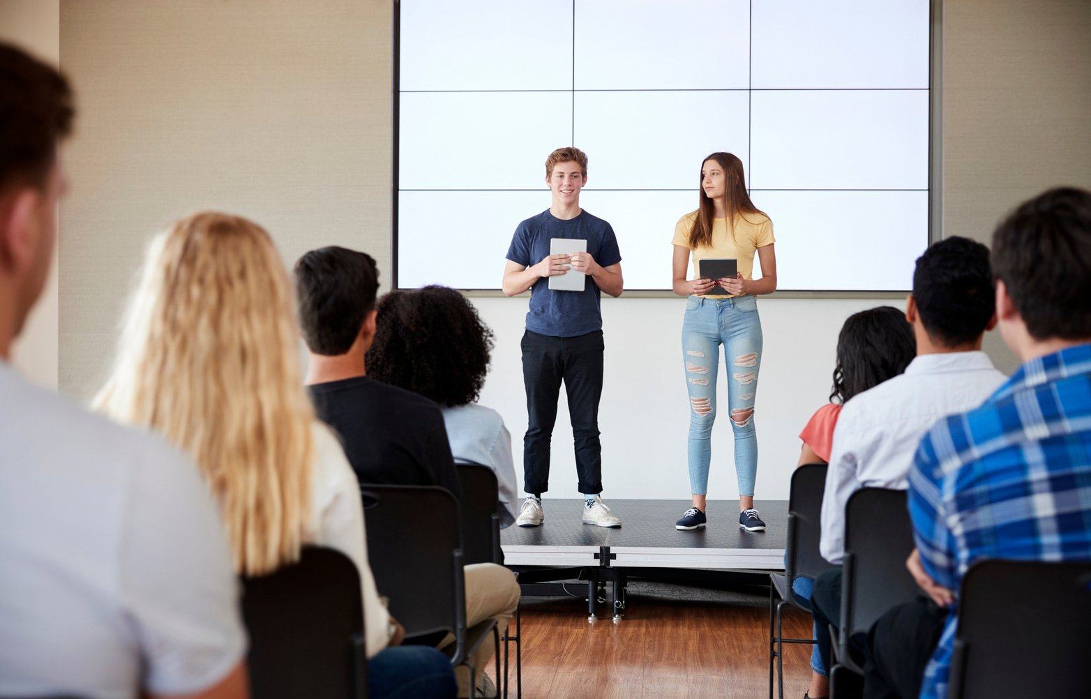 Students with Digital Tablets Giving Presentation to High School